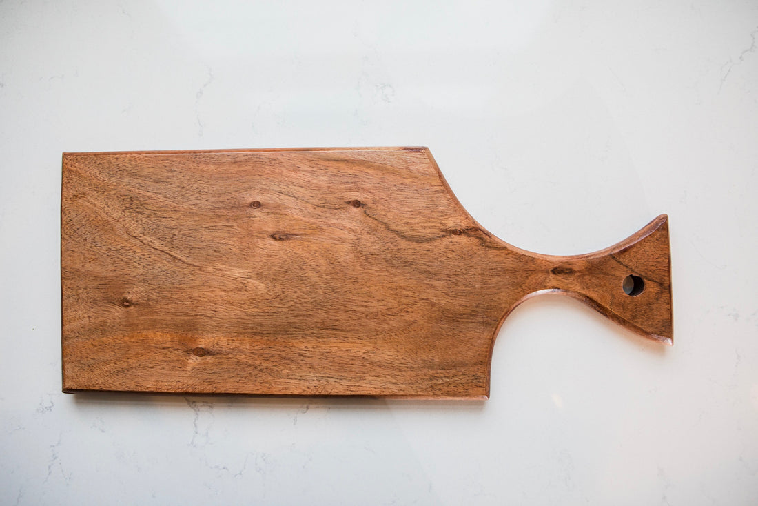 Wooden cutting board with a handle on a white background