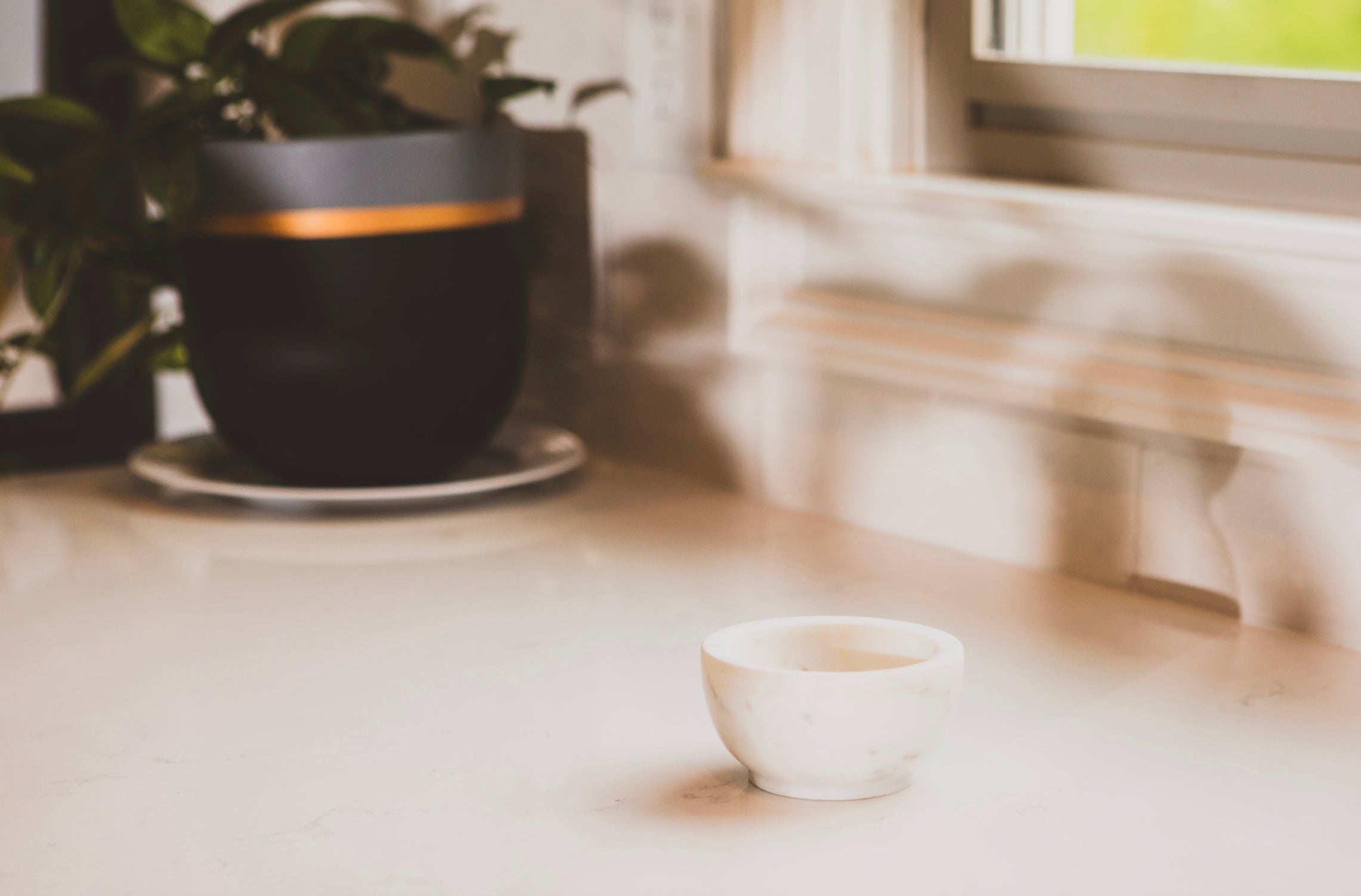 White ceramic cup on a light wooden surface with a blurred background