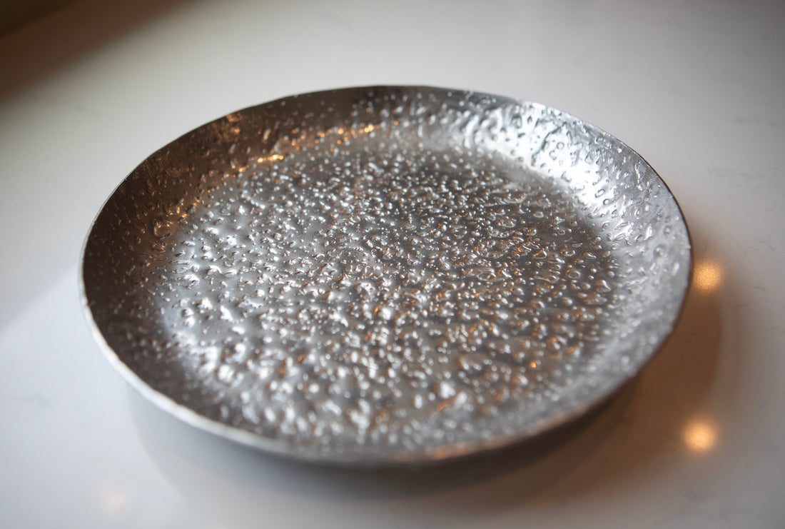 Silver textured bowl on a white surface