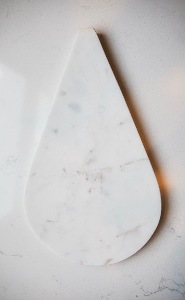 Marble cutting board on a light gray surface