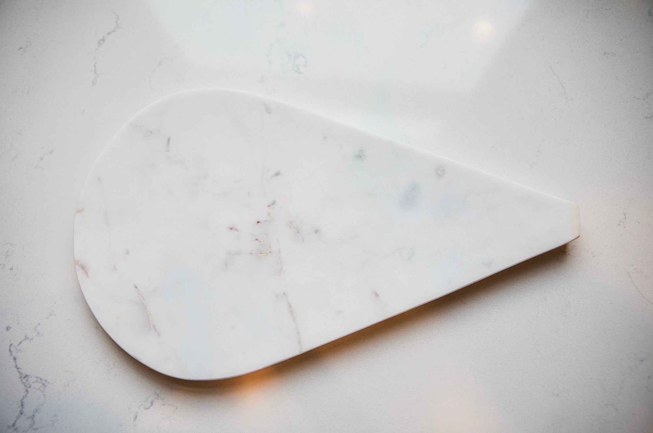 Marble cutting board on a light gray surface