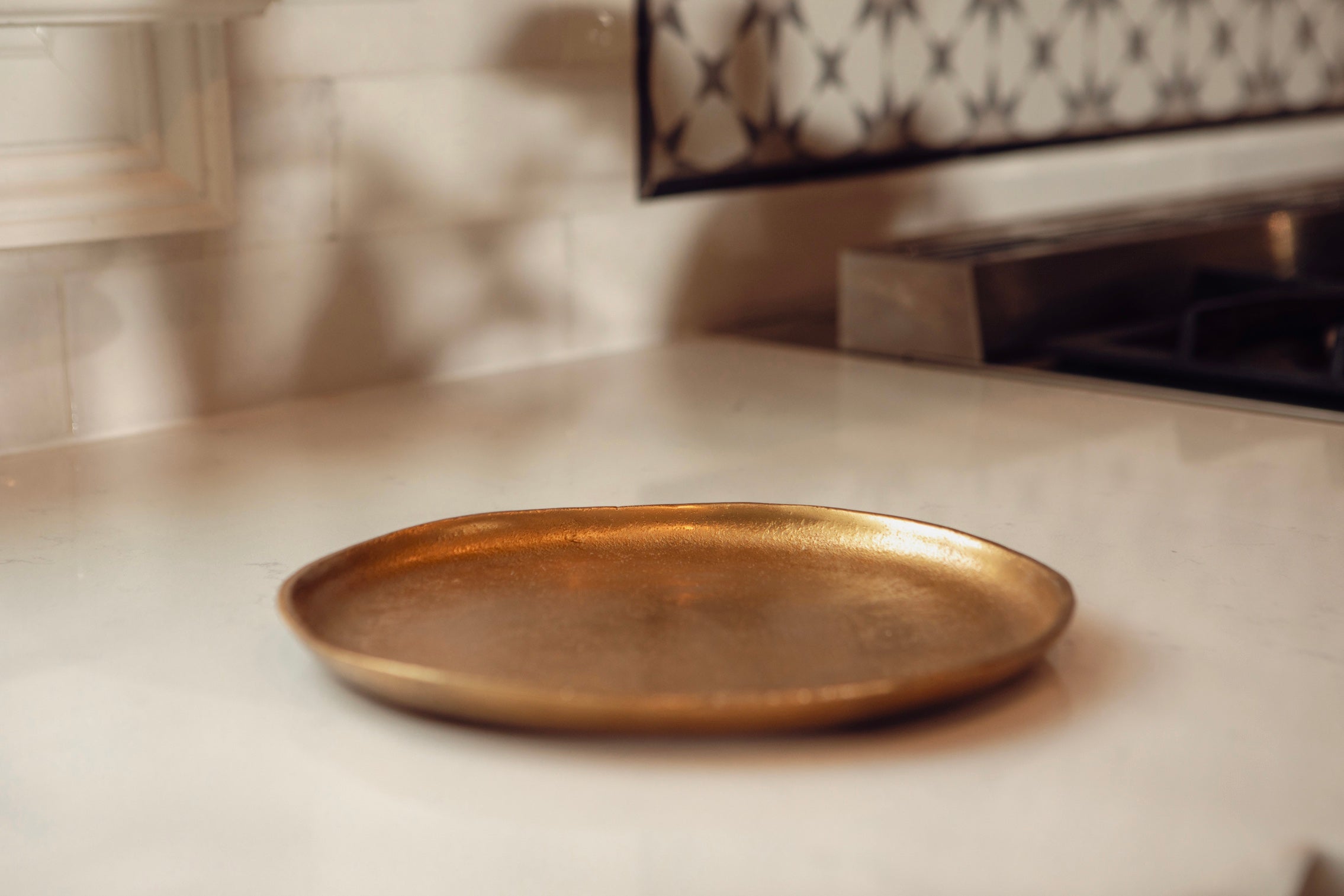 Bronze tray on a kitchen counter with a blurred background
