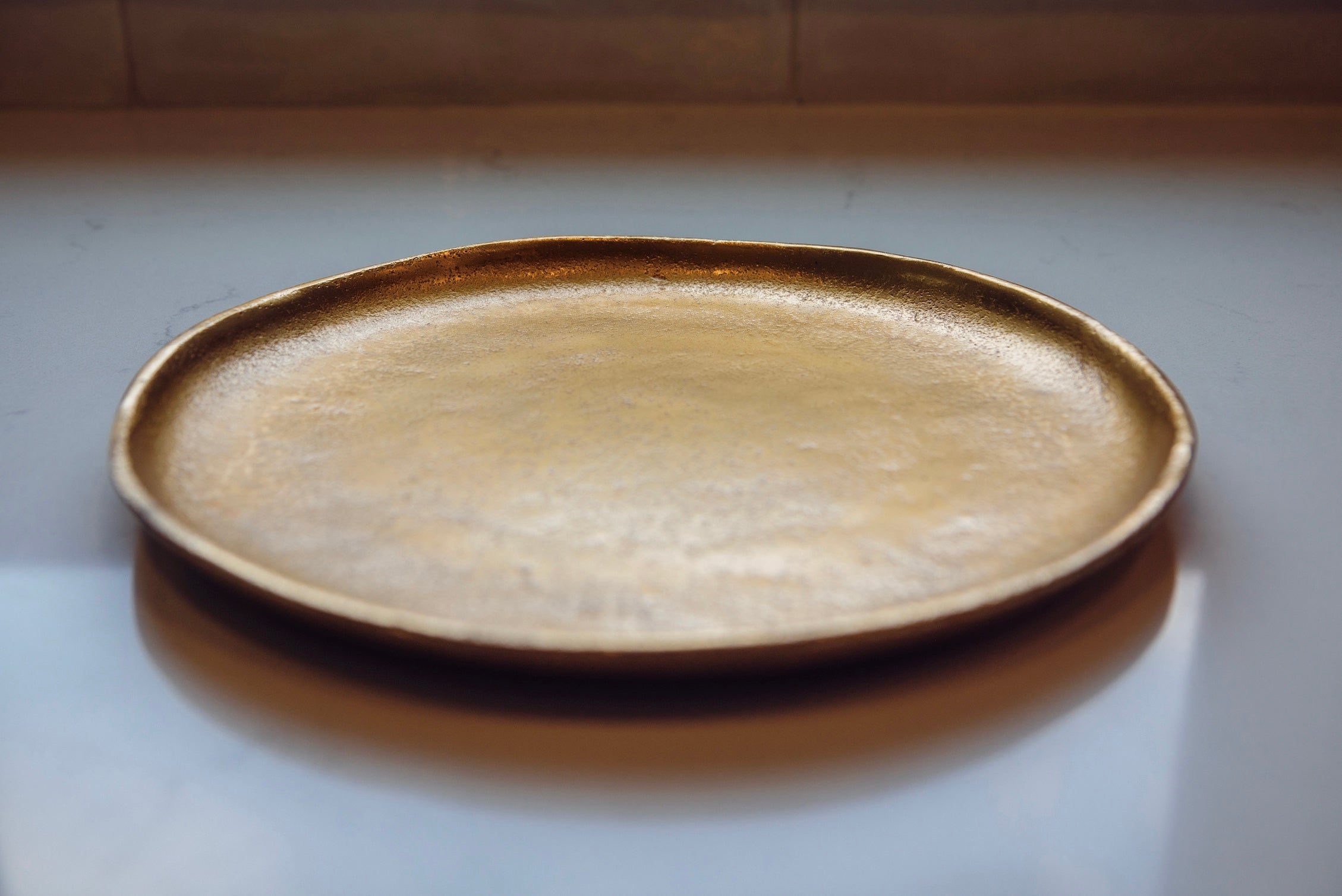 Round ceramic plate with a textured surface on a light background