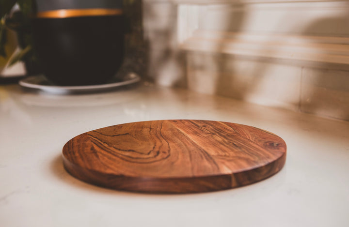 Wooden coaster on a light surface with a blurred background