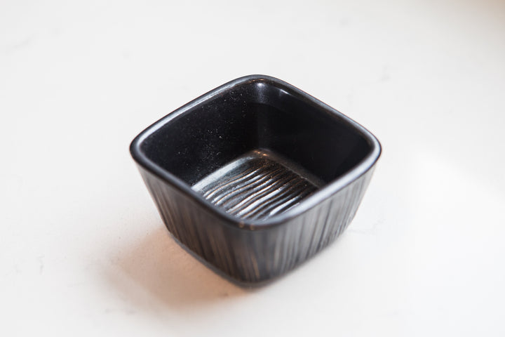 Black ceramic dish on a white background